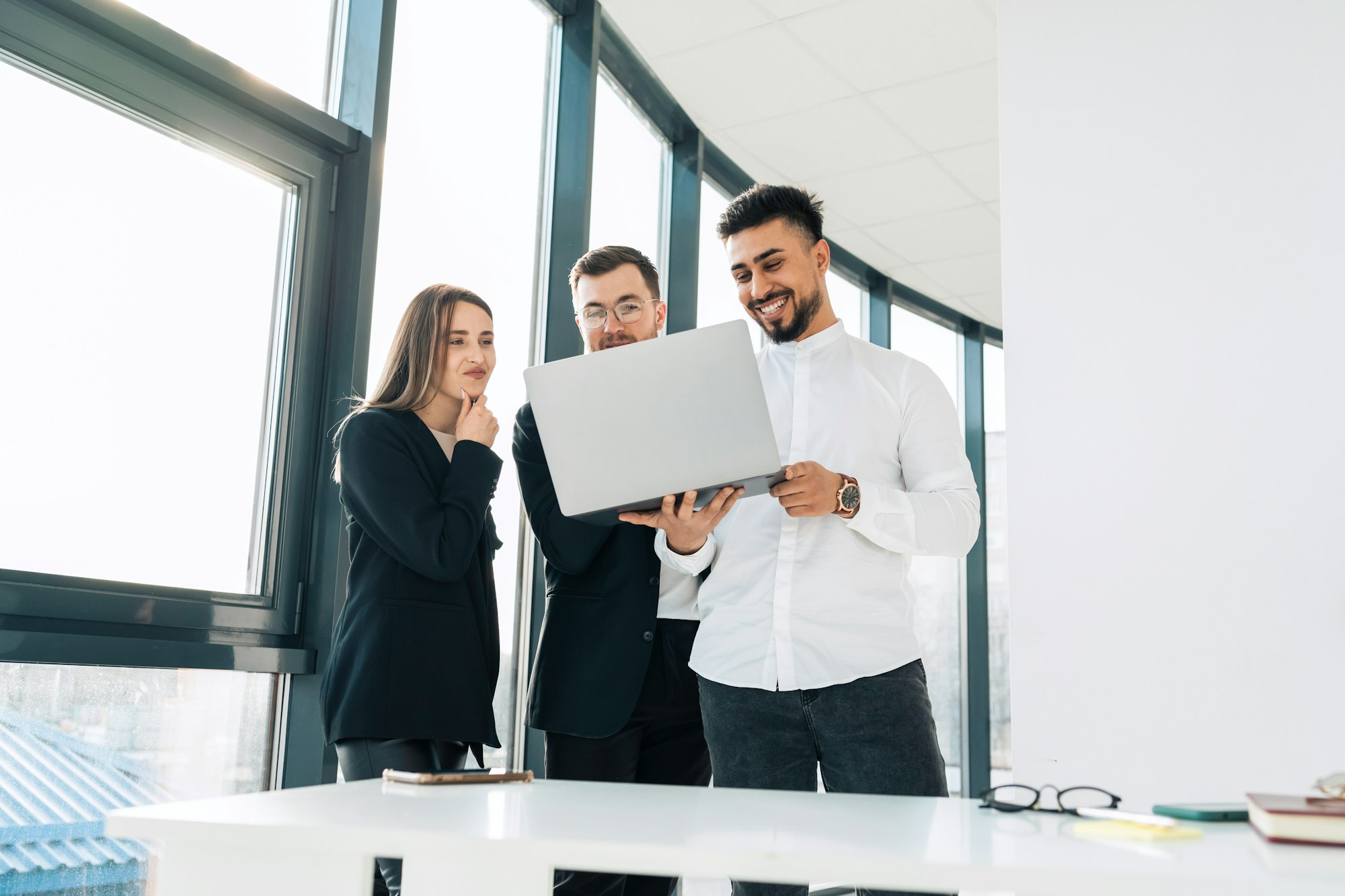 Employees of the IT company show their boss the process of developing new software