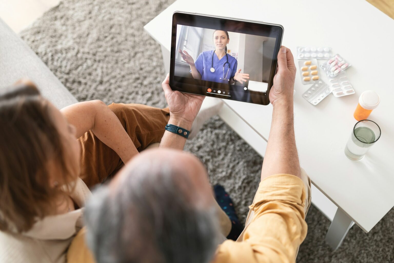 Using eHealth and telemedicine services at home. Senior couple using digital tablet having video